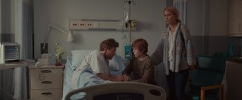 Movie still from “The Shack” (2017), directed by Stuart Hazeldine – A man and a boy sitting in a hospital bed; Medium shot, Over the shoulder angle