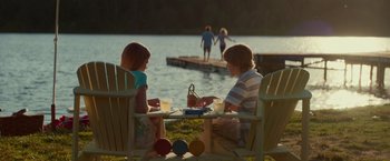 Movie still from “The Shack” (2017), directed by Stuart Hazeldine – Two people sitting at a table near a body of water; Wide shot, Over the shoulder angle