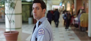 Movie still from “Fear X” (2003), directed by Nicolas Winding Refn – A security guard standing in a hallway of a building; Medium shot, Low angle