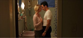 Movie still from “Fear X” (2003), directed by Nicolas Winding Refn – A man and a woman standing in a bathroom; Medium shot, Low angle