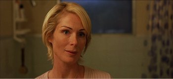 Movie still from “Fear X” (2003), directed by Nicolas Winding Refn – A person with short blonde hair; Close Up shot, Over the shoulder angle