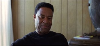 Movie still from “Fear X” (2003), directed by Nicolas Winding Refn – A person wearing a black shirt; Close Up shot, Low angle