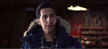 Movie still from “Fear X” (2003), directed by Nicolas Winding Refn – A person wearing a jacket; Close Up shot, Low angle