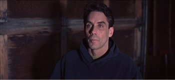 Movie still from “Fear X” (2003), directed by Nicolas Winding Refn – A person wearing a hooded sweatshirt; Close Up shot, Low angle