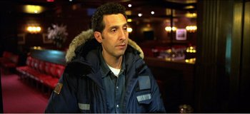 Movie still from “Fear X” (2003), directed by Nicolas Winding Refn – A person wearing a jacket; Close Up shot, Over the shoulder angle