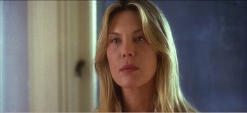 Movie still from “Fear X” (2003), directed by Nicolas Winding Refn – A person with long blonde hair; Close Up shot, Low angle