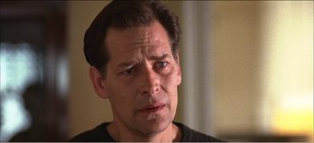 Movie still from “Fear X” (2003), directed by Nicolas Winding Refn – A person looking at the camera; Close Up shot, Low angle