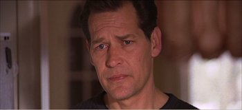 Movie still from “Fear X” (2003), directed by Nicolas Winding Refn – A person looking at the camera; Close Up shot, High angle