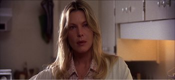 Movie still from “Fear X” (2003), directed by Nicolas Winding Refn – A person with long blonde hair; Close Up shot, Over the shoulder angle