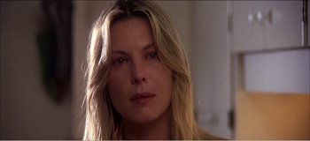 Movie still from “Fear X” (2003), directed by Nicolas Winding Refn – A person with long blonde hair; Close Up shot, Over the shoulder angle