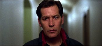 Movie still from “Fear X” (2003), directed by Nicolas Winding Refn – A person wearing a jacket; Close Up shot, Low angle