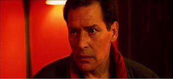 Movie still from “Fear X” (2003), directed by Nicolas Winding Refn – A person wearing a jacket; Close Up shot, Low angle