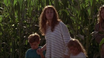 Movie still from “Fearless” (1993), directed by Peter Weir – A woman standing next to two young children; Medium shot, Low angle