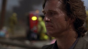 Movie still from “Fearless” (1993), directed by Peter Weir – A man's face with a fire truck in the background; Close Up shot, Low angle