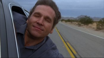 Movie still from “Fearless” (1993), directed by Peter Weir – A person taking a selfie on the side of the road; Close Up shot, Low angle