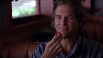 Movie still from “Fearless” (1993), directed by Peter Weir – A person eating a piece of food; Close Up shot, Over the shoulder angle