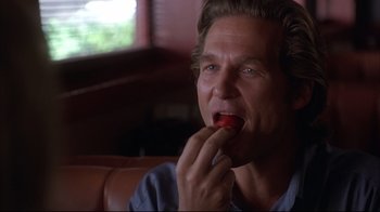 Movie still from “Fearless” (1993), directed by Peter Weir – A person eating a piece of food; Close Up shot, Over the shoulder angle