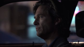 Movie still from “Fearless” (1993), directed by Peter Weir – A person in a car; Close Up shot, Over the shoulder angle