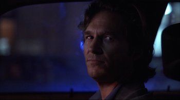 Movie still from “Fearless” (1993), directed by Peter Weir – A person in a dark room; Close Up shot, Over the shoulder angle