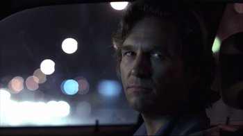 Movie still from “Fearless” (1993), directed by Peter Weir – A person in a car at night; Close Up shot, Over the shoulder angle