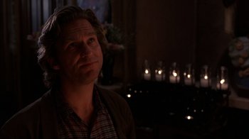 Movie still from “Fearless” (1993), directed by Peter Weir – A man in a plaid shirt is looking at the camera; Close Up shot, Over the shoulder angle