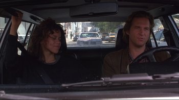 Movie still from “Fearless” (1993), directed by Peter Weir – A man and a woman sitting in the back of a car; Medium shot, Over the shoulder angle