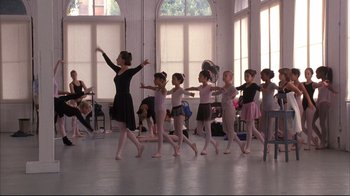 Movie still from “Fearless” (1993), directed by Peter Weir – A group of young ballerinas practicing in a studio; Wide shot, Low angle