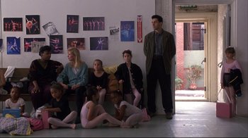 Movie still from “Fearless” (1993), directed by Peter Weir – A group of people sitting and standing in a room; Wide shot, High angle