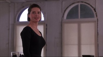 Movie still from “Fearless” (1993), directed by Peter Weir – A woman in a black dress standing in front of a window; Medium shot, Low angle