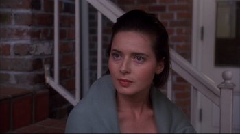 Movie still from “Fearless” (1993), directed by Peter Weir – A person sitting on a chair near a railing; Close Up shot, Over the shoulder angle