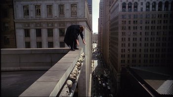 Movie still from “Fearless” (1993), directed by Peter Weir – A man standing on the edge of a building on a ledge; Wide shot, Overhead angle