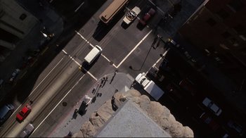 Movie still from “Fearless” (1993), directed by Peter Weir – An aerial view of a city street with cars and buses; Extreme Wide shot, Overhead angle