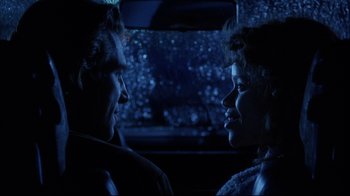 Movie still from “Fearless” (1993), directed by Peter Weir – A man and a woman sitting in the back of a car; Close Up shot, Over the shoulder angle