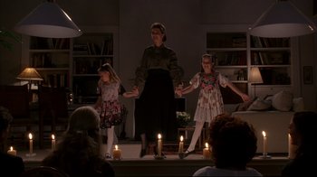 Movie still from “Fearless” (1993), directed by Peter Weir – A woman and two girls are performing a show; Wide shot, High angle