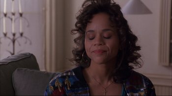 Movie still from “Fearless” (1993), directed by Peter Weir – A person sitting on a couch with her eyes closed; Close Up shot, High angle