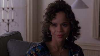 Movie still from “Fearless” (1993), directed by Peter Weir – A person sitting on a couch; Close Up shot, Over the shoulder angle