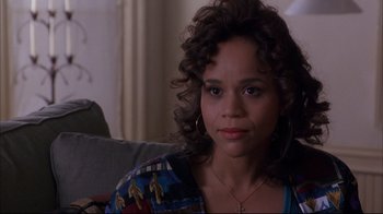 Movie still from “Fearless” (1993), directed by Peter Weir – A person sitting on a couch; Close Up shot, Over the shoulder angle