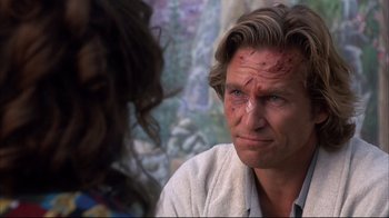 Movie still from “Fearless” (1993), directed by Peter Weir – A person wearing a white shirt with red spots; Close Up shot, Over the shoulder angle