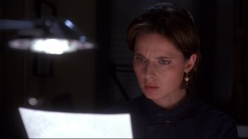 Movie still from “Fearless” (1993), directed by Peter Weir – A woman looking at a computer screen in the dark; Close Up shot, Over the shoulder angle