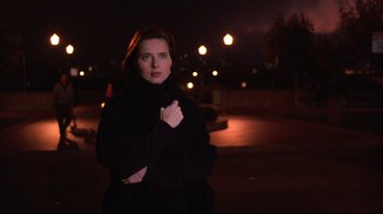 Movie still from “Fearless” (1993), directed by Peter Weir – A woman standing in the dark at night; Medium shot, Low angle