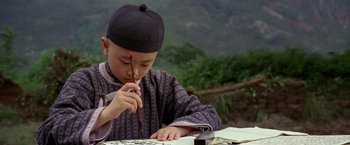 Movie still from “Fearless” (2006), directed by Ronny Yu – A young boy is writing on a piece of paper; Close Up shot, High angle
