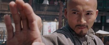 Movie still from “Fearless” (2006), directed by Ronny Yu – A man's face and hand; Close Up shot, Over the shoulder angle