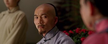 Movie still from “Fearless” (2006), directed by Ronny Yu – A man with a shaved head and a beard; Close Up shot, Over the shoulder angle