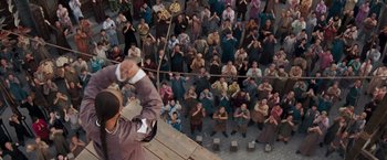 Movie still from “Fearless” (2006), directed by Ronny Yu – An overhead view of a crowd of people sitting and standing; Extreme Wide shot, High angle