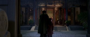 Movie still from “Fearless” (2006), directed by Ronny Yu – A man and a woman walking in front of a building; Wide shot, Over the shoulder angle