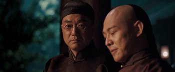 Movie still from “Fearless” (2006), directed by Ronny Yu – Two asian men in black and white outfits; Close Up shot, Over the shoulder angle