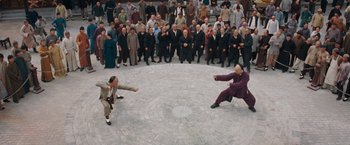 Movie still from “Fearless” (2006), directed by Ronny Yu – Two men are fighting in front of a crowd of onlookers; Extreme Wide shot, High angle