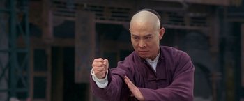 Movie still from “Fearless” (2006), directed by Ronny Yu – A man in a purple shirt is doing a punch; Close Up shot, Low angle