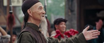 Movie still from “Fearless” (2006), directed by Ronny Yu – An old man with a long white beard; Close Up shot, Over the shoulder angle