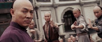 Movie still from “Fearless” (2006), directed by Ronny Yu – A group of men standing next to each other on a street; Close Up shot, Over the shoulder angle